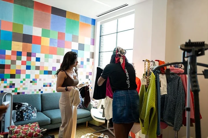 a women helping another women with choosing clothes